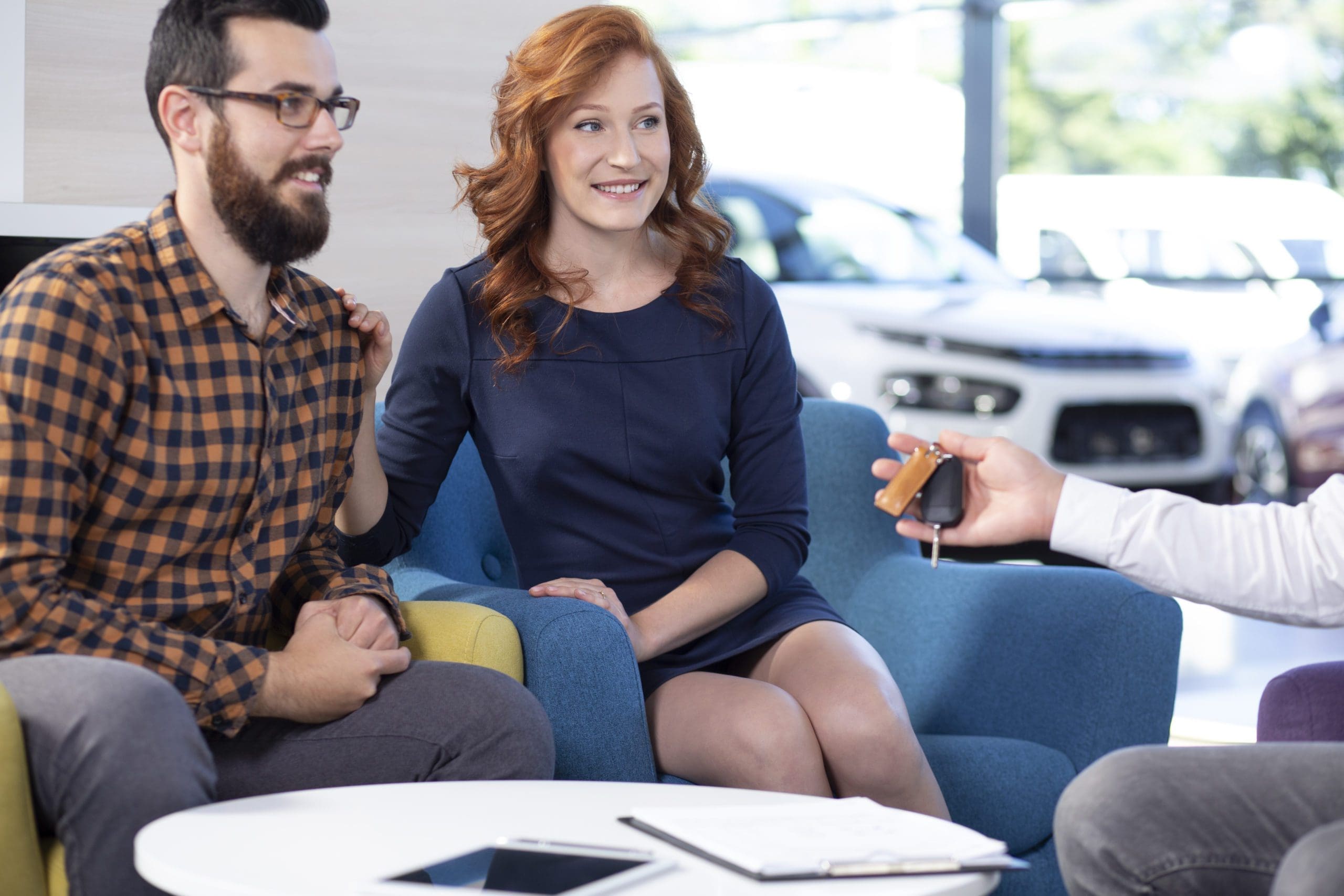Smiling and happy marriage buying a new car in exclusive showroo